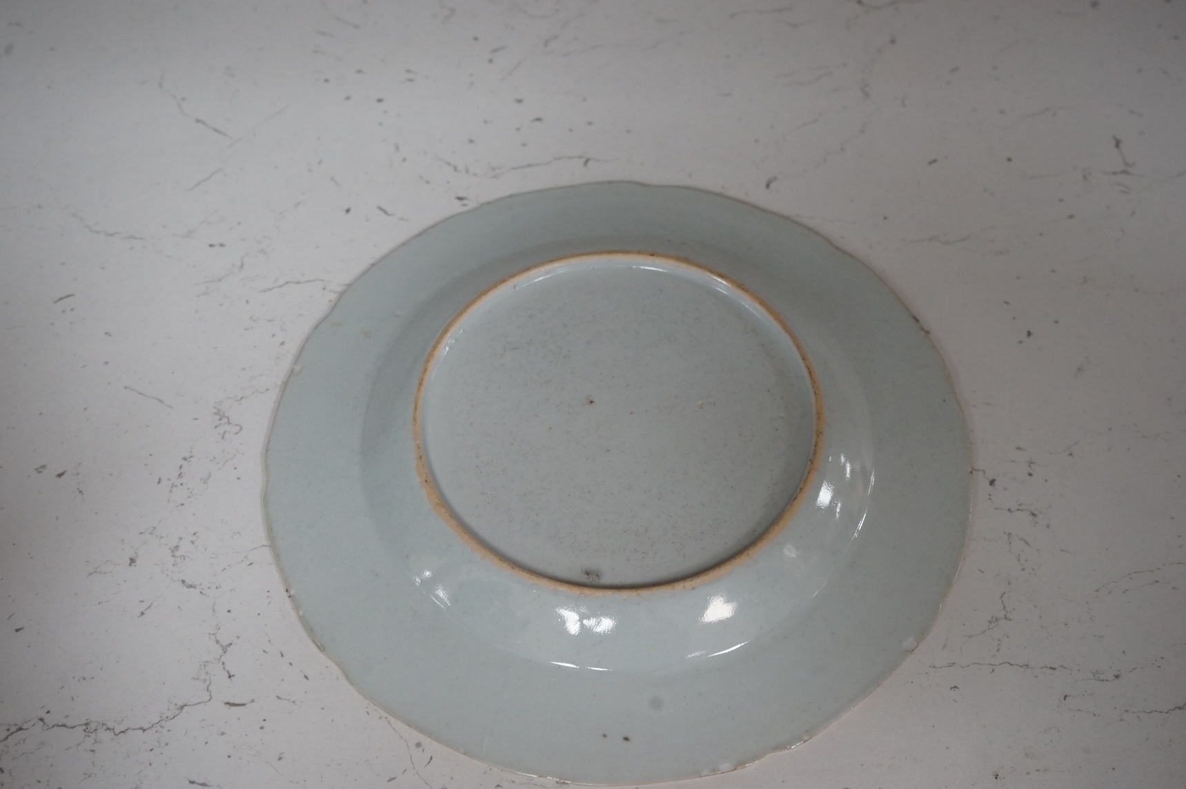Three Chinese famille rose plates, Qianlong, including an armorial example, largest 22.5cm in diameter